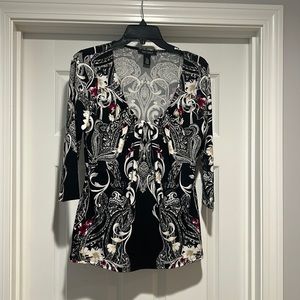 Black top with floral design.